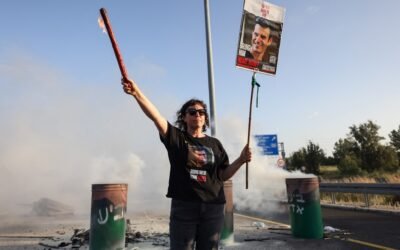 PHOTO: A woman holds a sign with a photograph of Israeli hostage Dror Or on April 19, 2024, during a protest calling for his release.
